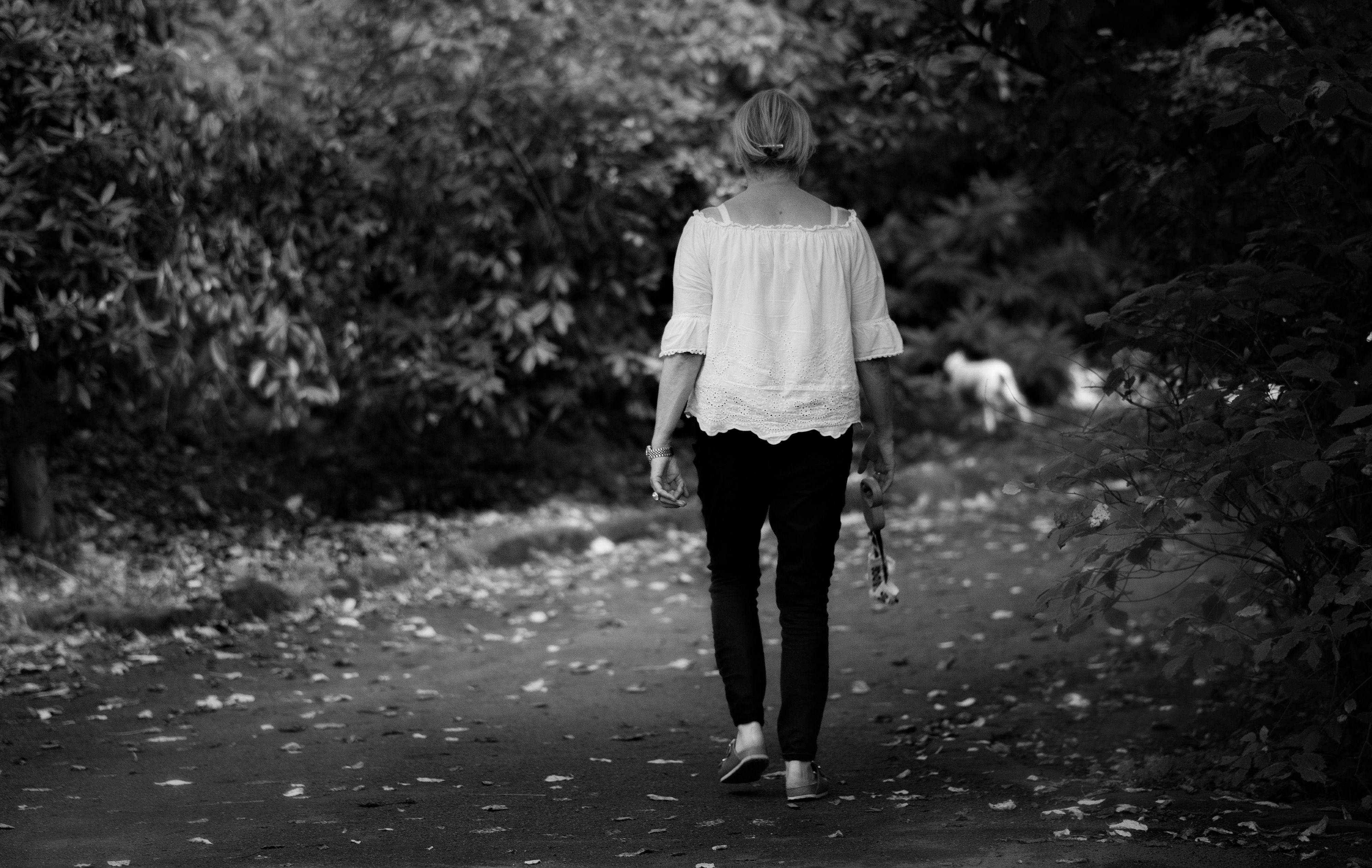 Grayscale Photography of a Woman Walking on the Street · Free Stock Photo