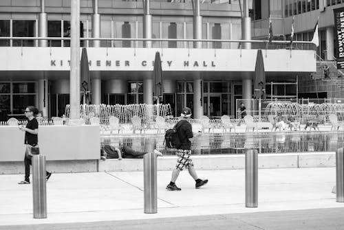 A Person Walking Near the Kitchener City Hall in Ontario, Canada