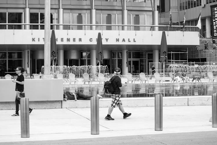 A Person Walking Near The Kitchener City Hall In Ontario, Canada