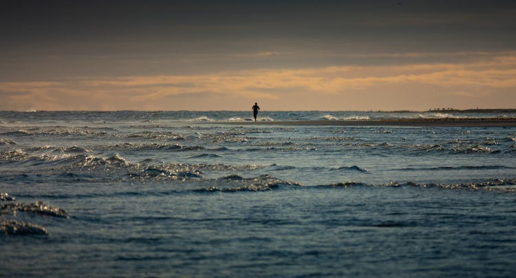 Sportsperson Running On The Beach