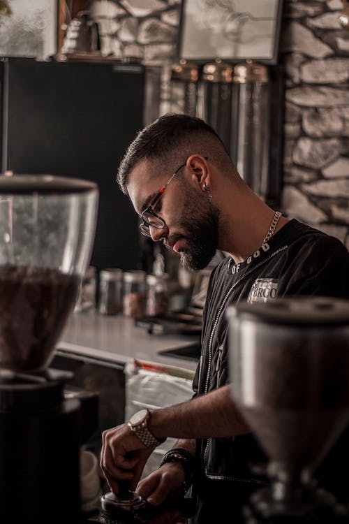 A Bearded Man in Black Shirt Making Coffee at the Bar