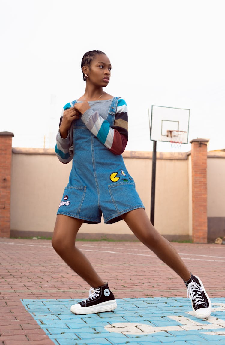 A Young Woman In Denim Jumper Dancing 