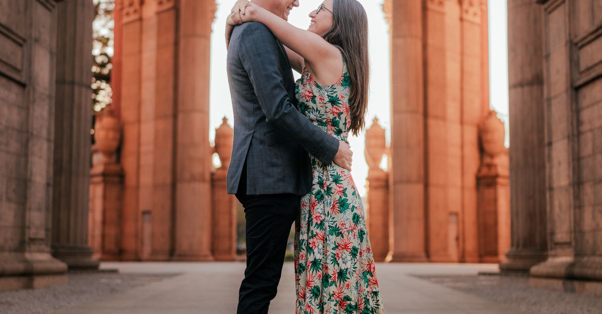 A Couple Hugging Near Brown Building · Free Stock Photo