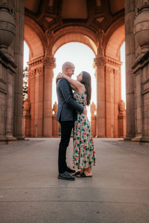 A Couple Hugging Near Brown Building · Free Stock Photo