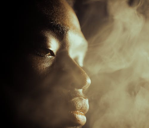 A Close Up Shot of a Man with Smoke