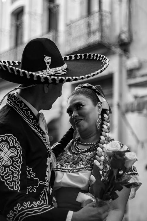 Grayscale Photo of a Couple Wearing a Traditional Mexican Clothes