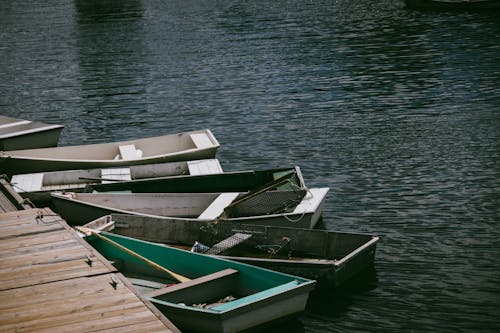 Wooden Boats Docked on the Side of the River