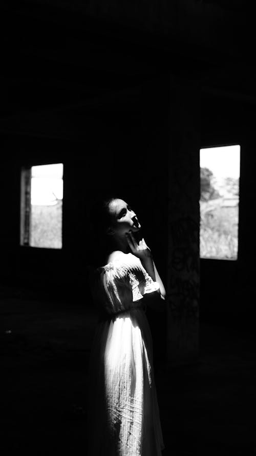 Grayscale Photo of Woman in White Dress