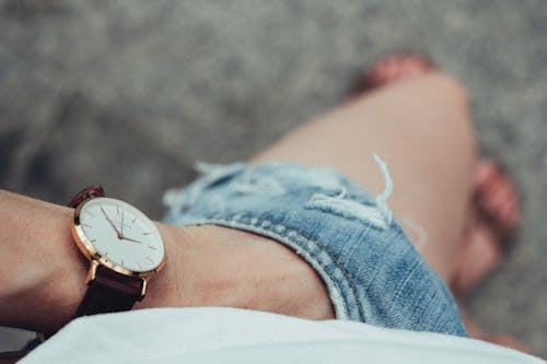 Person Wearing Wristwatch and Denim Shorts