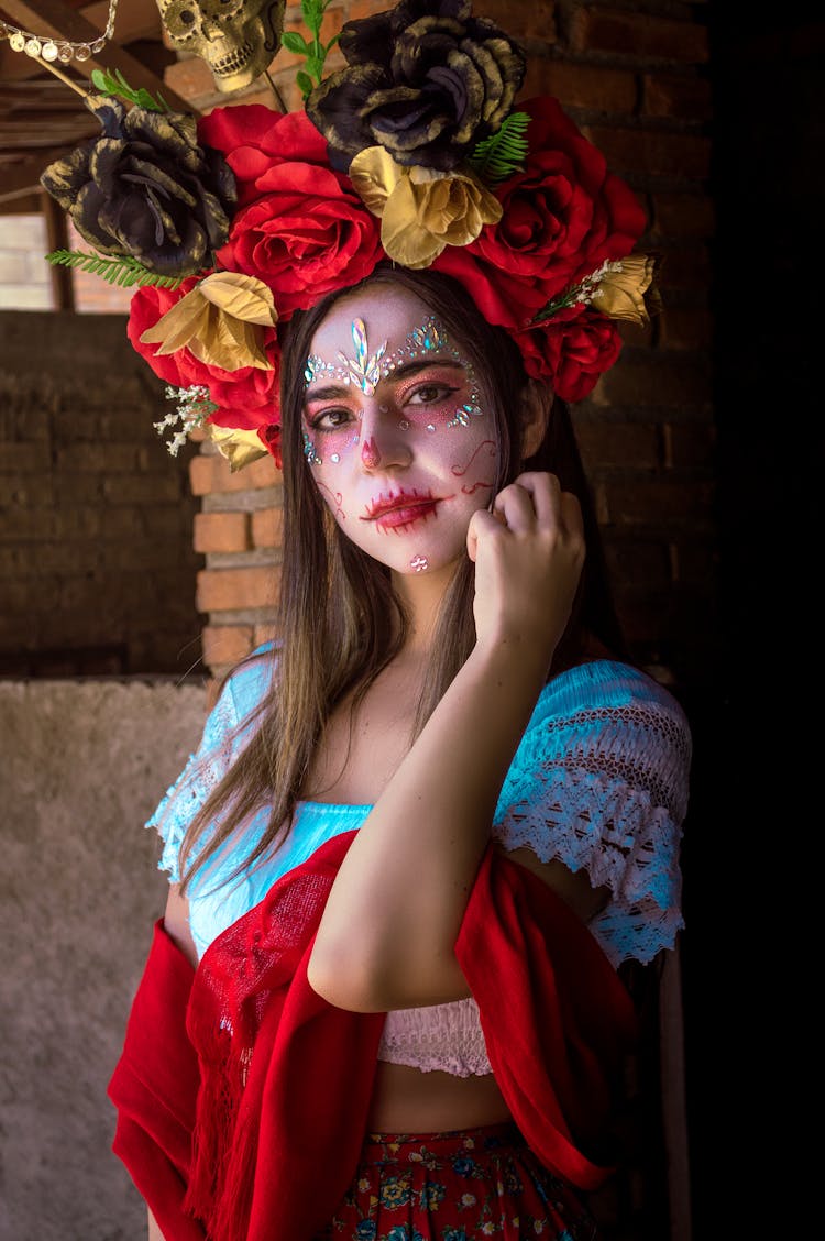 A Woman With Face Paint Wearing A Floral Headdress