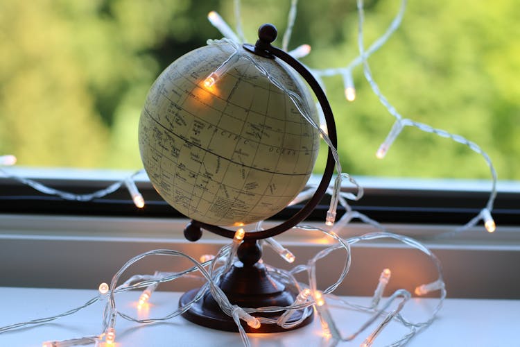 White And Black Desk Globe With White String Lights