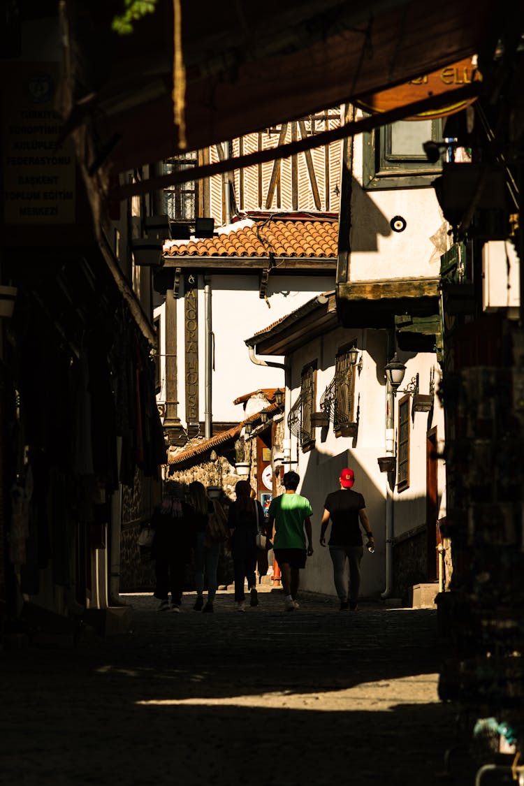 A Group Of People Walking On Street