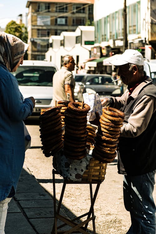 A Person Standing Near Pile of Brown Bread 