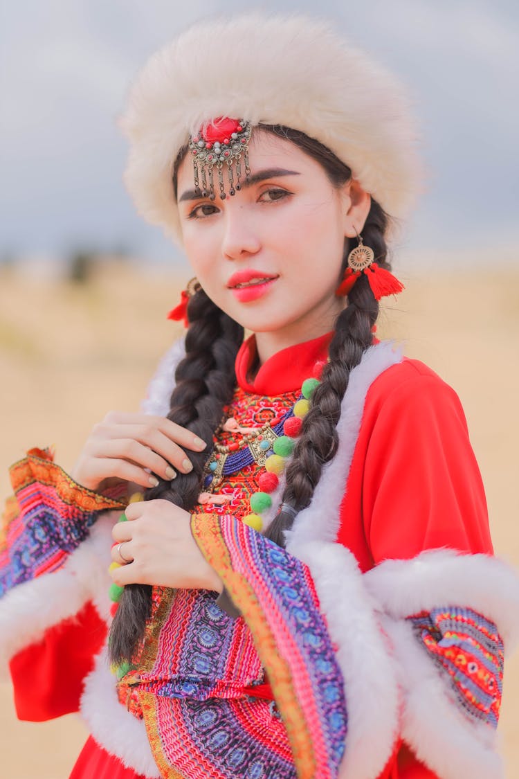  A Woman Wearing Red And White Traditional Costume And White Fur Hat