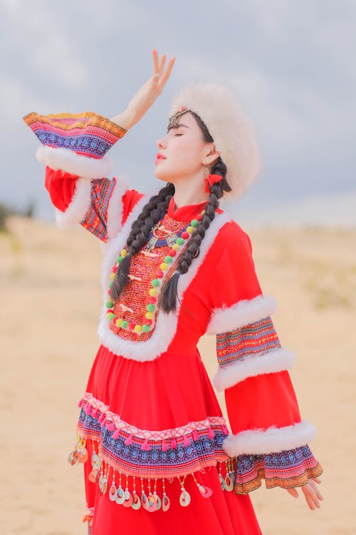 Free Young Woman in Traditional Clothing on the Beach  Stock Photo