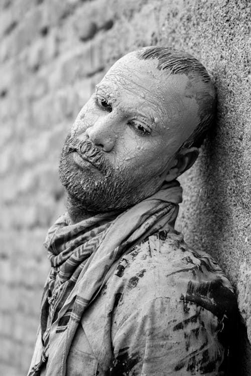 Man with Face Paint Posing near Wall