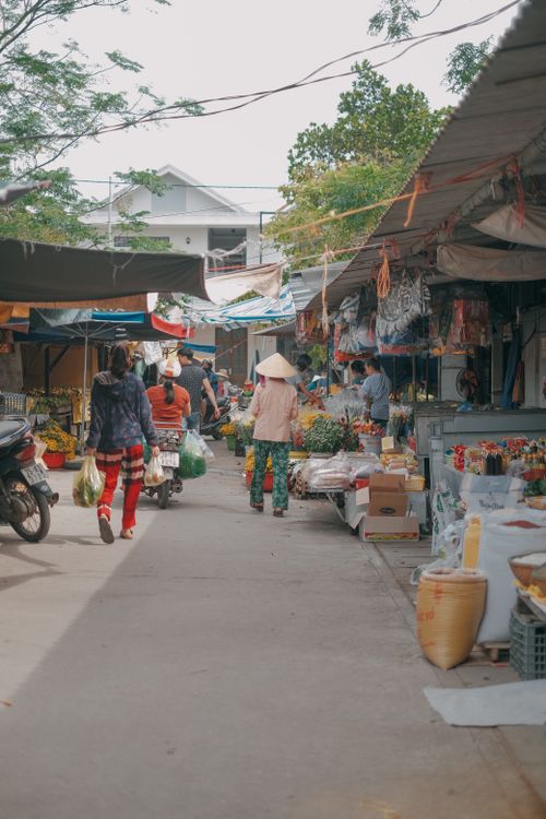 Free A bustling street market filled with diverse stalls and shoppers in daytime. Stock Photo
