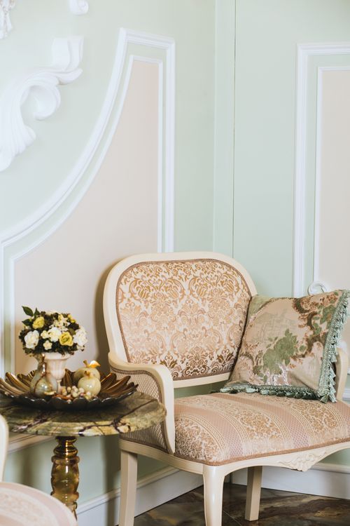 Free Elegant armchair and decor in a detailed interior setting with soft lighting. Stock Photo