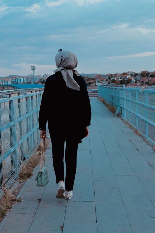 Back View of a Woman Holding a Bag