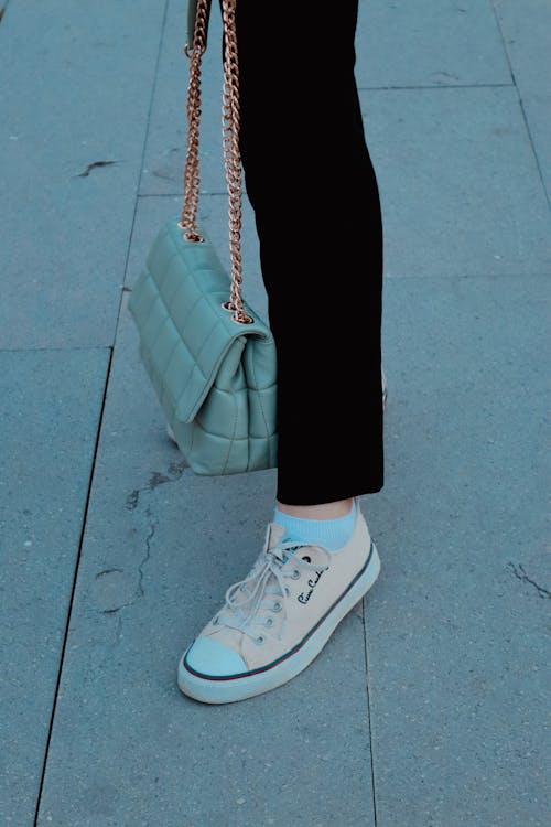 A Person in Black Pants and Beige Sneakers