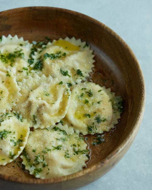 Free Rustic bowl filled with spinach ravioli drizzled with olive oil and herbs. Stock Photo