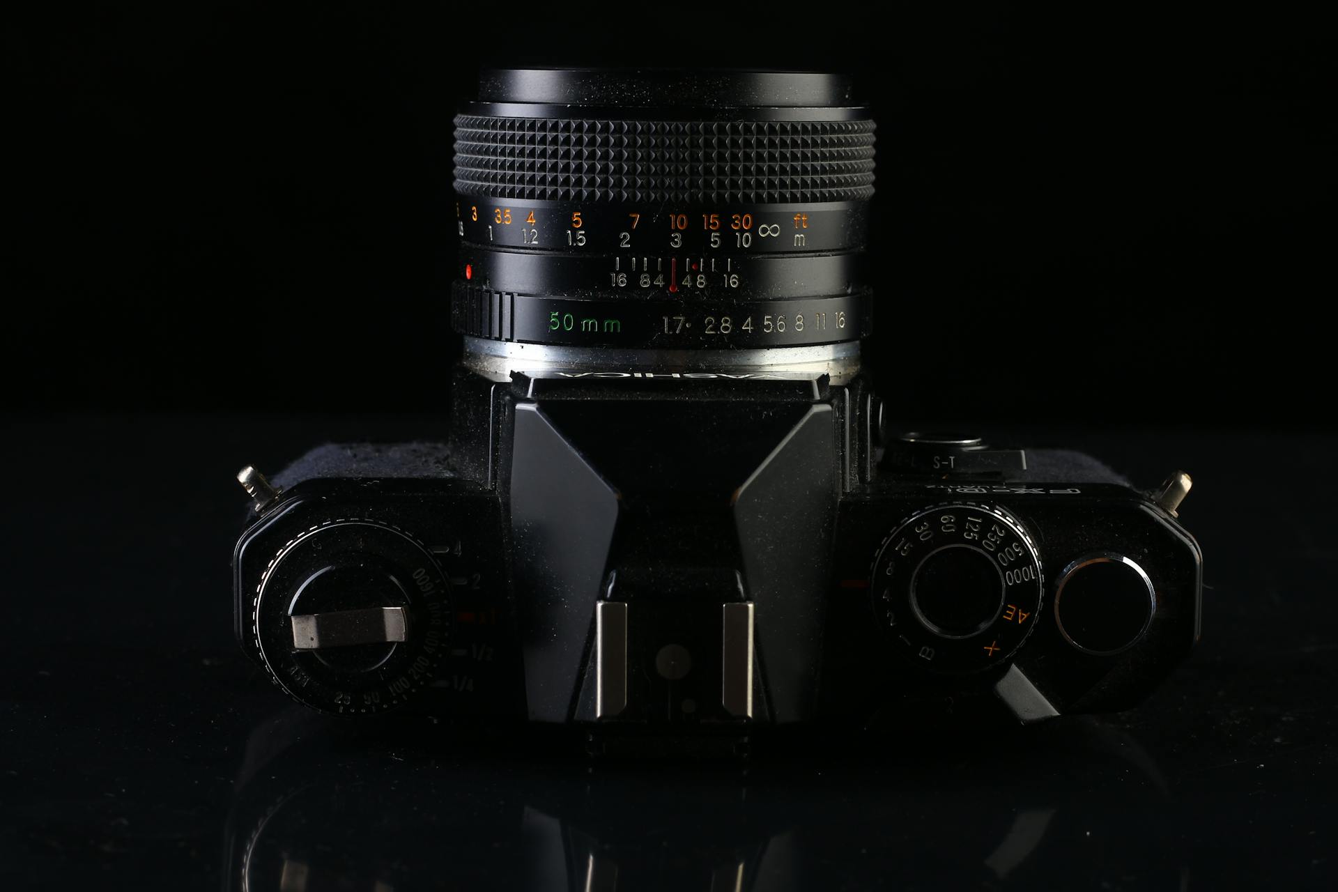 A close-up of a classic vintage camera with a 50mm lens, highlighting details and chrome finishes.