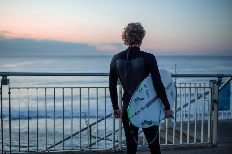 A Person Holding A Surfboard