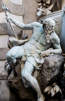 Intricate statue of Neptune at the Hofburg Palace in Vienna, Austria, showcasing classical art.