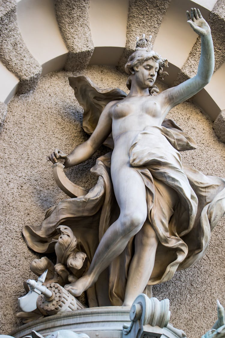 A Statue Of A Naked Woman In Low Angle Shot