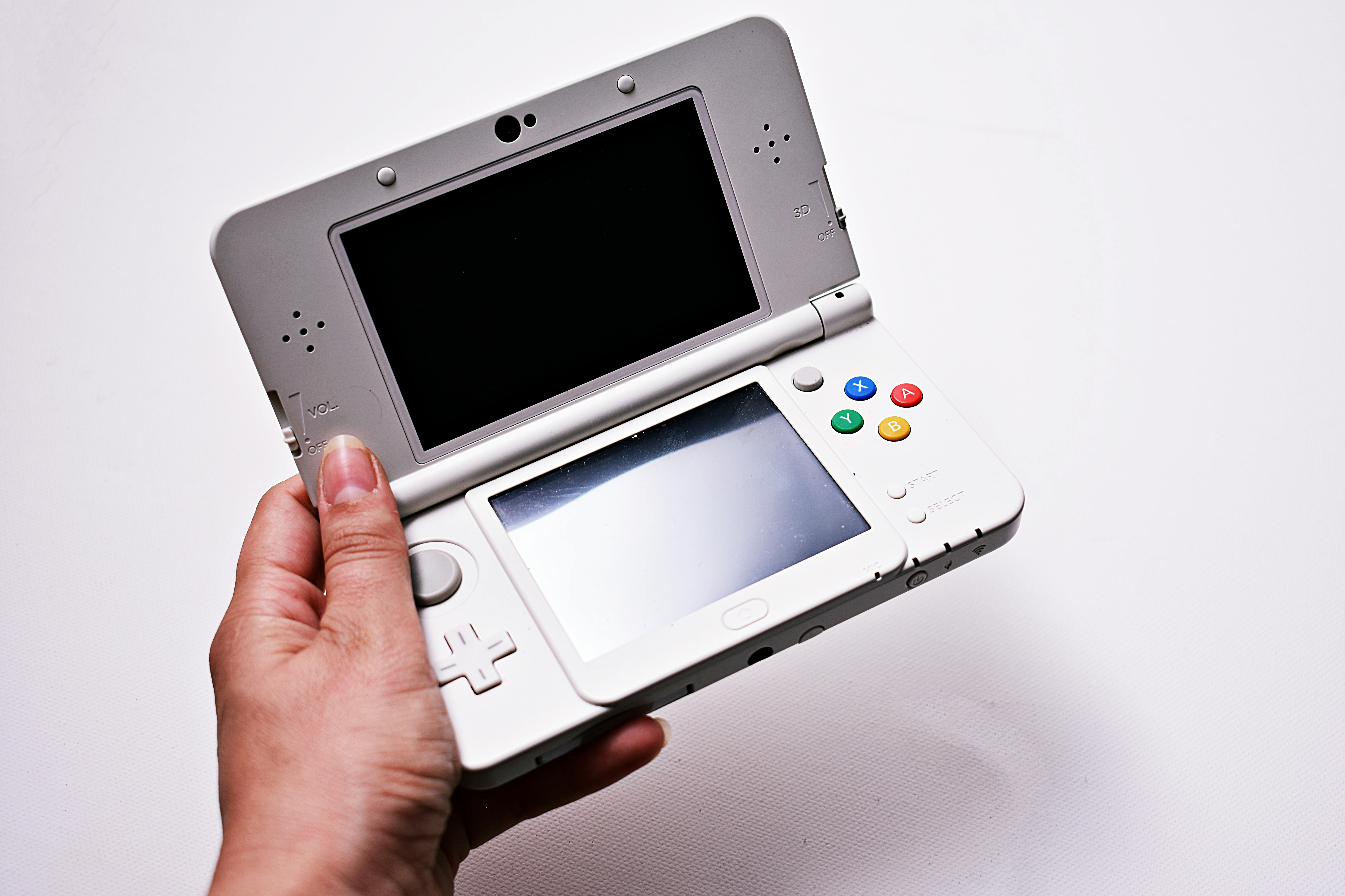 Person Holding Gray Nintendo Gameboy Advance Free Stock Photo