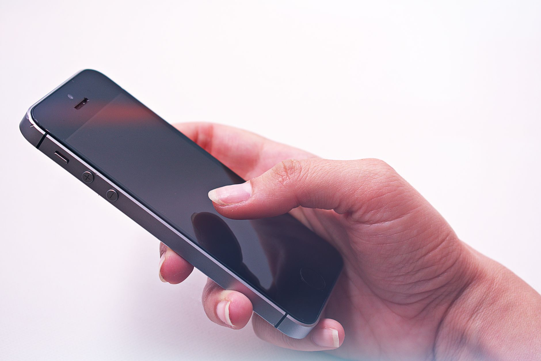 A person's hand holding a smartphone, showcasing modern technology and connectivity.