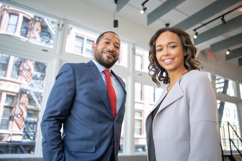 Free Man and Woman Smiling Inside Building Stock Photo