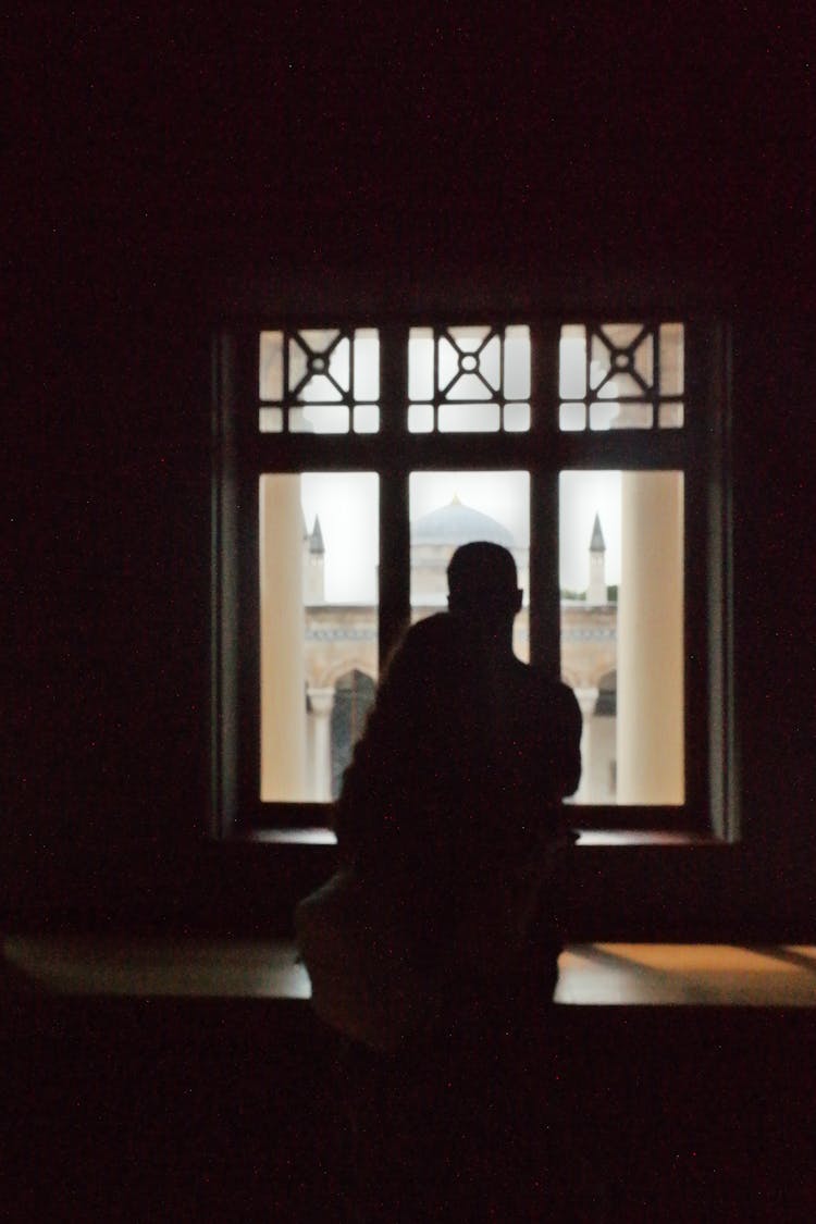 Silhouettes Of Couple In Dark Room