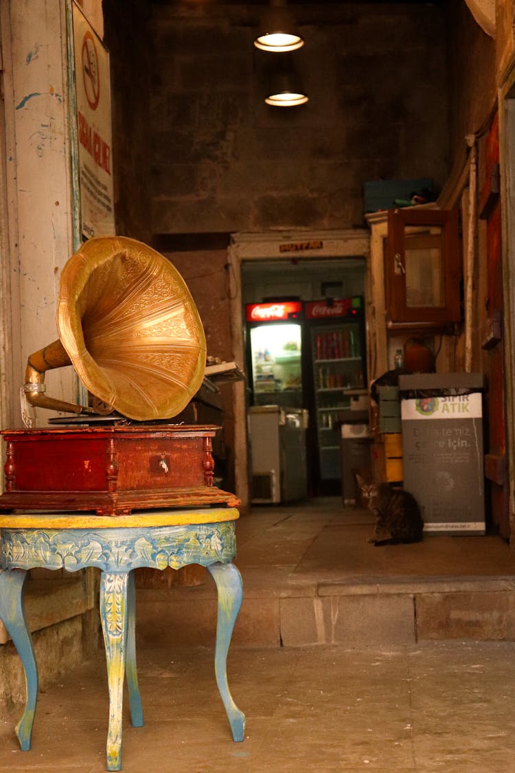 A Antique Brass Gramophone On The Table