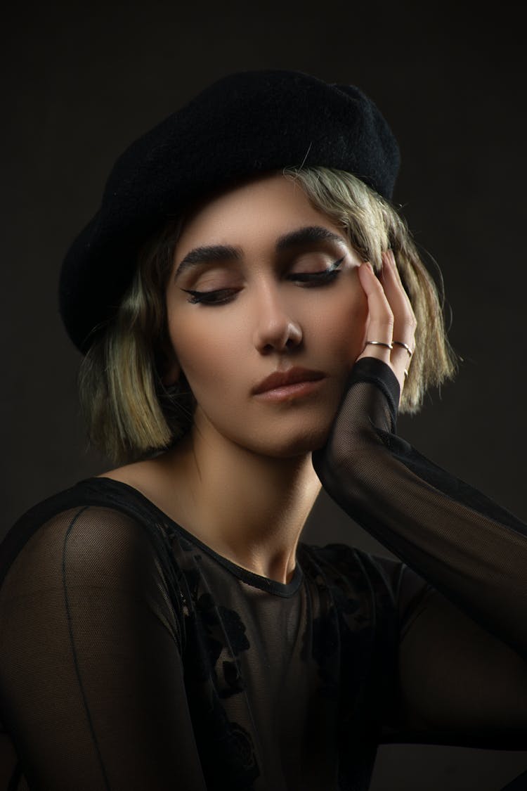 A Woman In Black Sheer Top With Black Hat