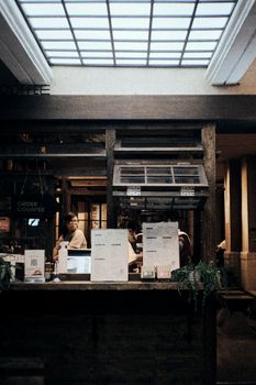An inviting coffee shop counter with attentive staff ready to serve customers.