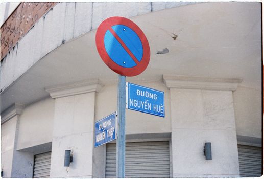 No parking sign and street signs on Nguyễn Huệ, urban Vietnamese street scene.