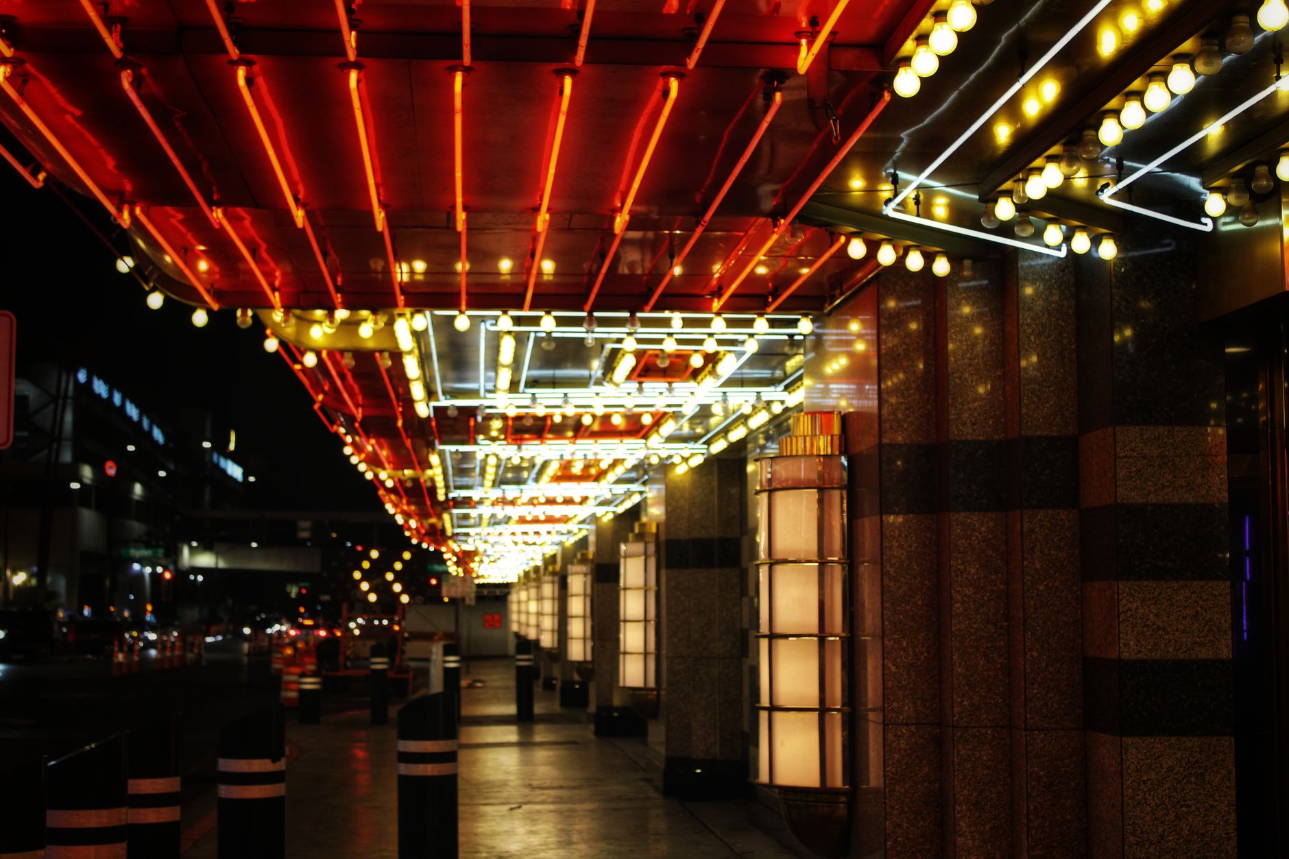 Bright neon lights illuminate a Las Vegas street, capturing the city's vibrant nightlife.