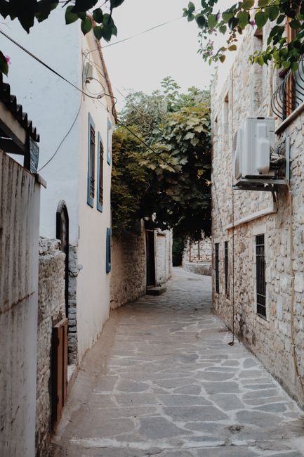 Explore a charming stone alley in a quaint village with classic architecture.