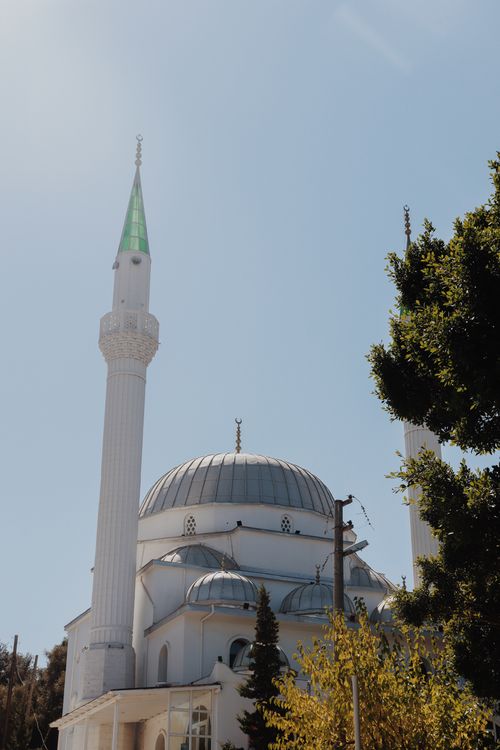 Free Beautiful mosque with tall minarets glowing in sunlight, showcasing Islamic architecture. Stock Photo
