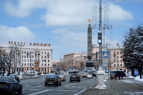Free A bustling scene of traffic at Victory Square, Minsk on a winter day, featuring the iconic monument. Stock Photo