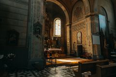 A beautifully lit interior of a historic Catholic church showcasing ornate architecture.