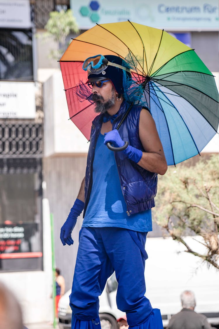 Hipster With Goggles And Umbrella