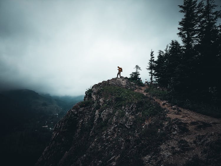 Man Standing In The Rocky Mountains