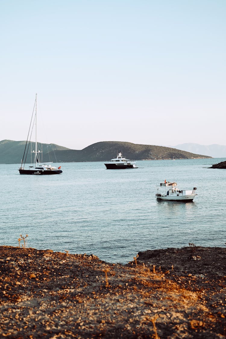 Ships Sailing On Sea Near Shore