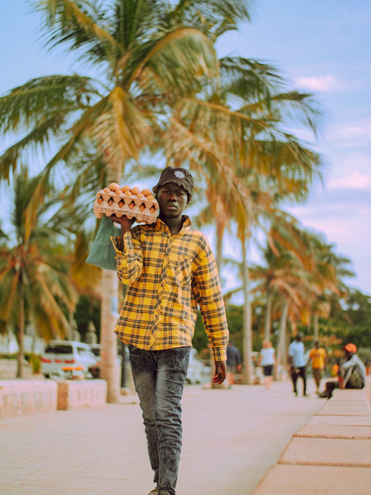 Walking Man Holding Cartons With Eggs On An Arm