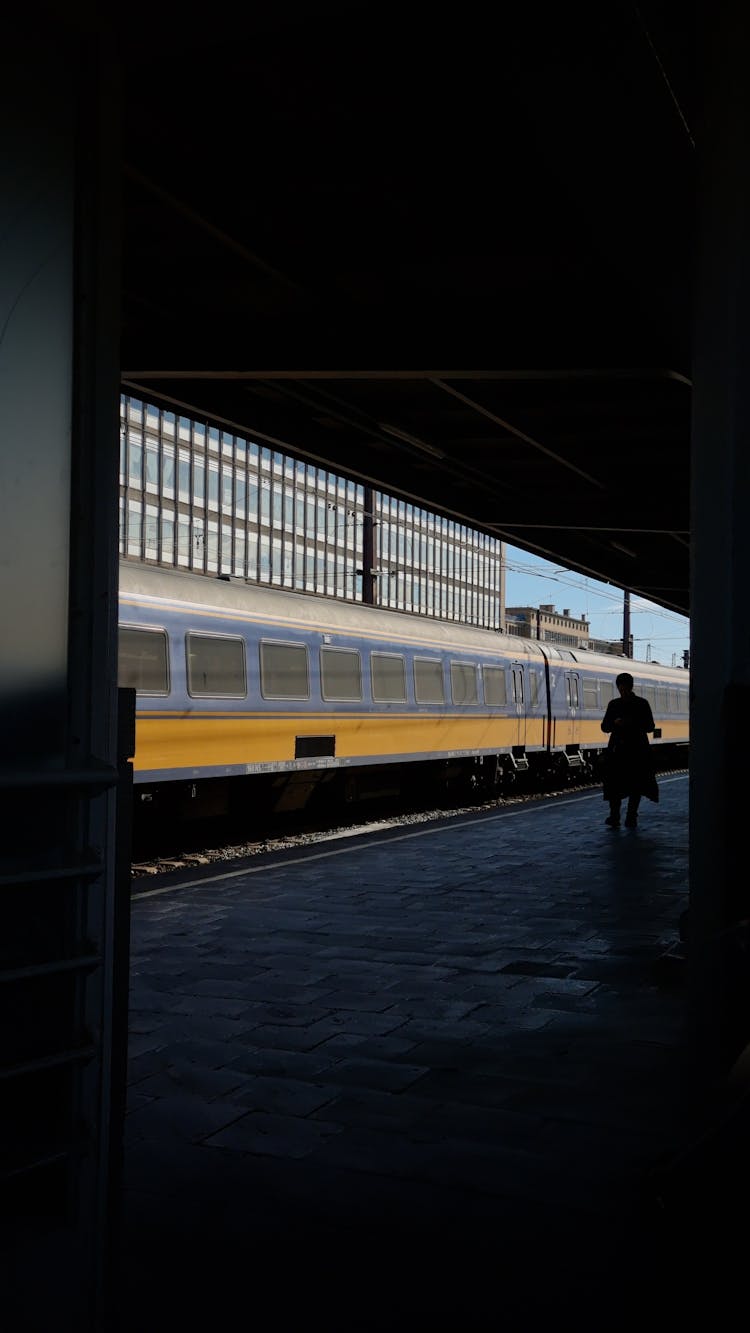 A Person Walking On Train Station