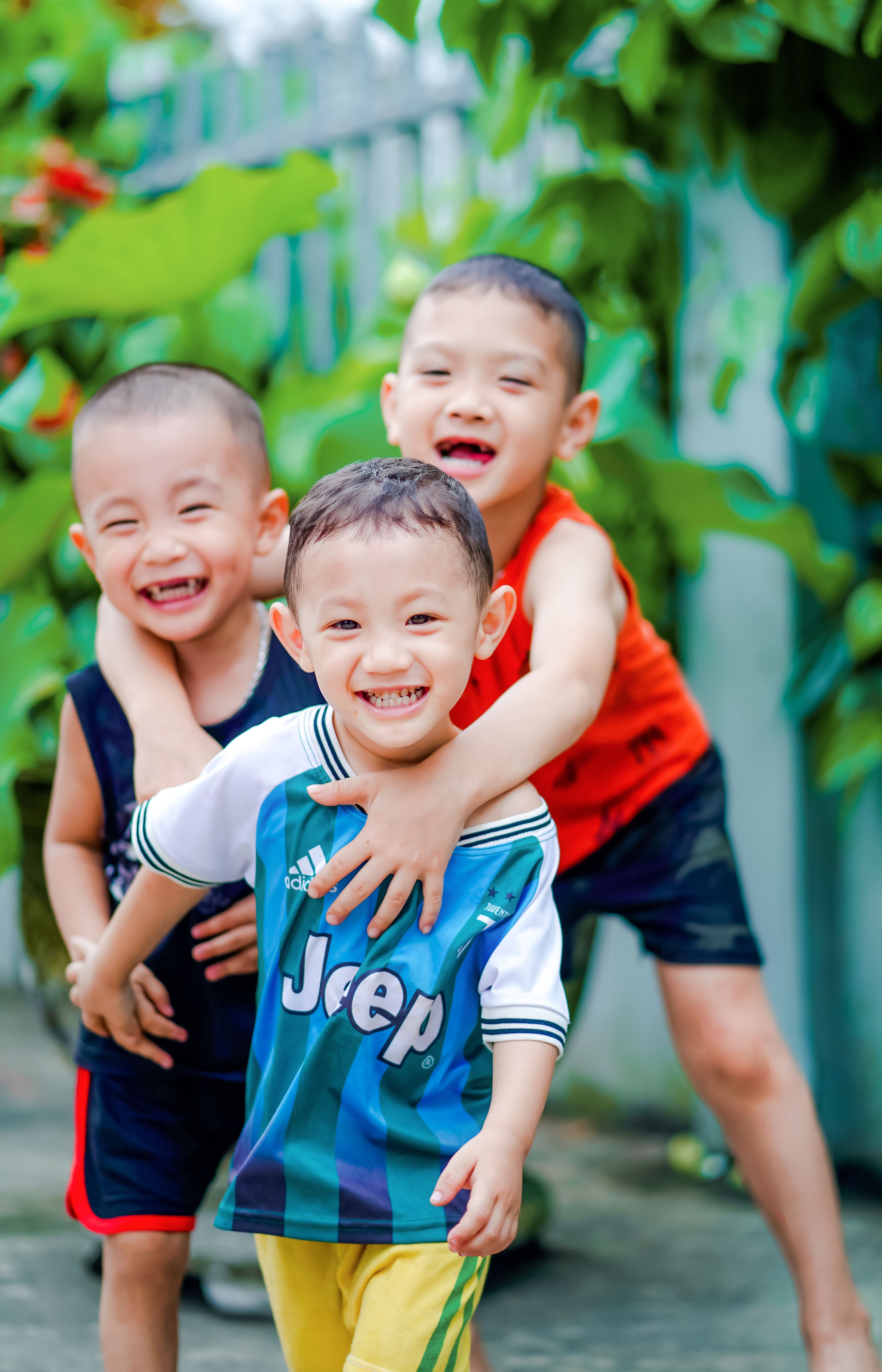 Three cheerful boys playing outdoors, capturing pure childhood joy.