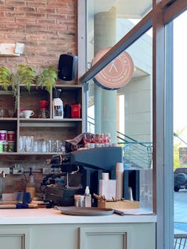 Inviting café corner in Valencia showcasing espresso machine and rustic brick wall.