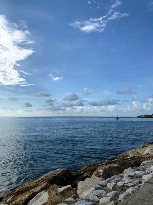 Free Peaceful seashore view with calm waters and blue sky in Puerto Cabello, Venezuela. Stock Photo